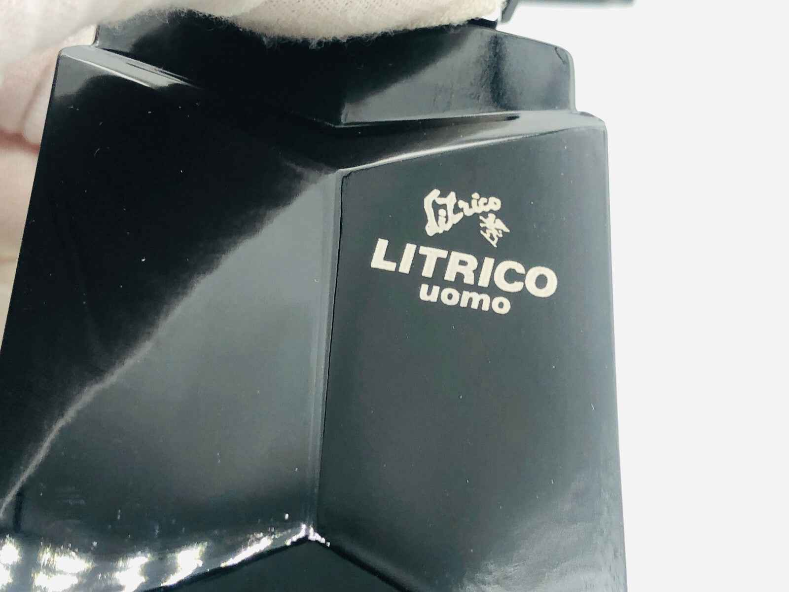 Dettaglio del prodotto Angelo Litrico Uomo Vintage con logo in oro su fondo nero lucido