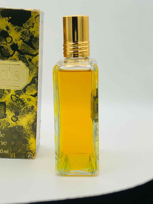 Vintage Aramis Cologne in a square glass bottle with a gold cap, featuring a yellow fragrance
