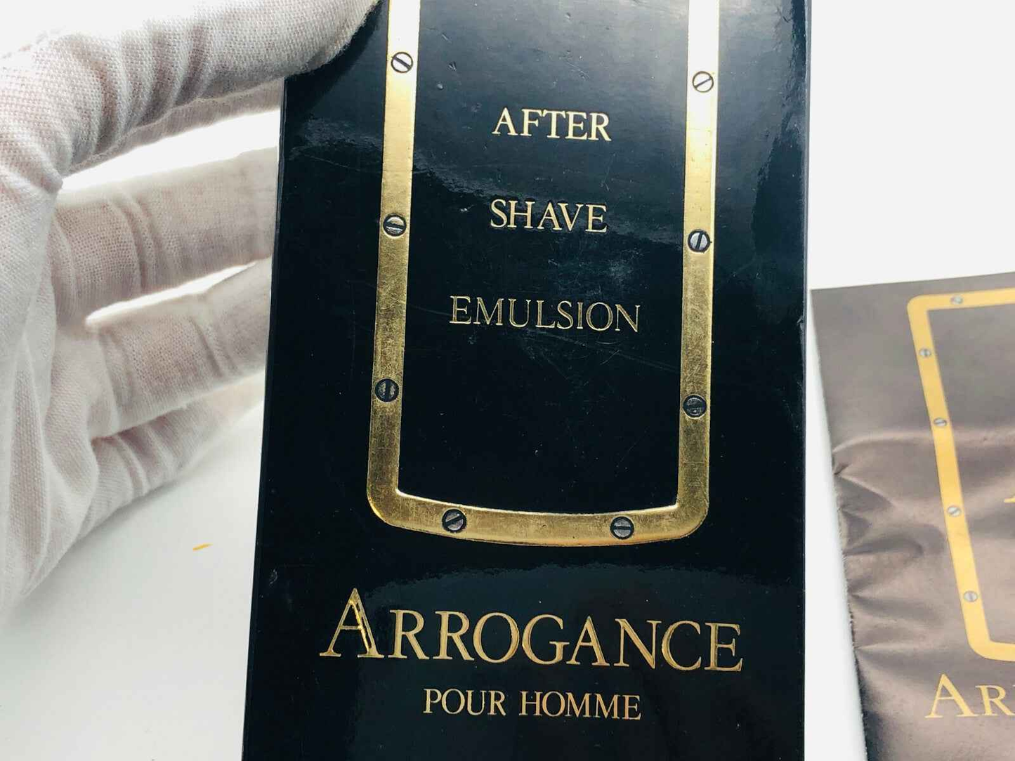 Emulsione dopobarba Arrogance Pour Homme con packaging elegante e dettagli dorati