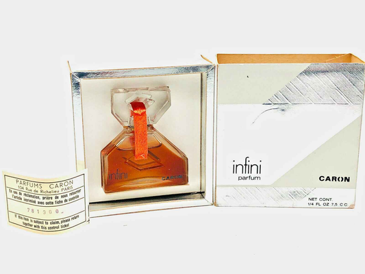 Profumo Infini Caron in flacone quadrato con nastro rosso e confezione elegante
