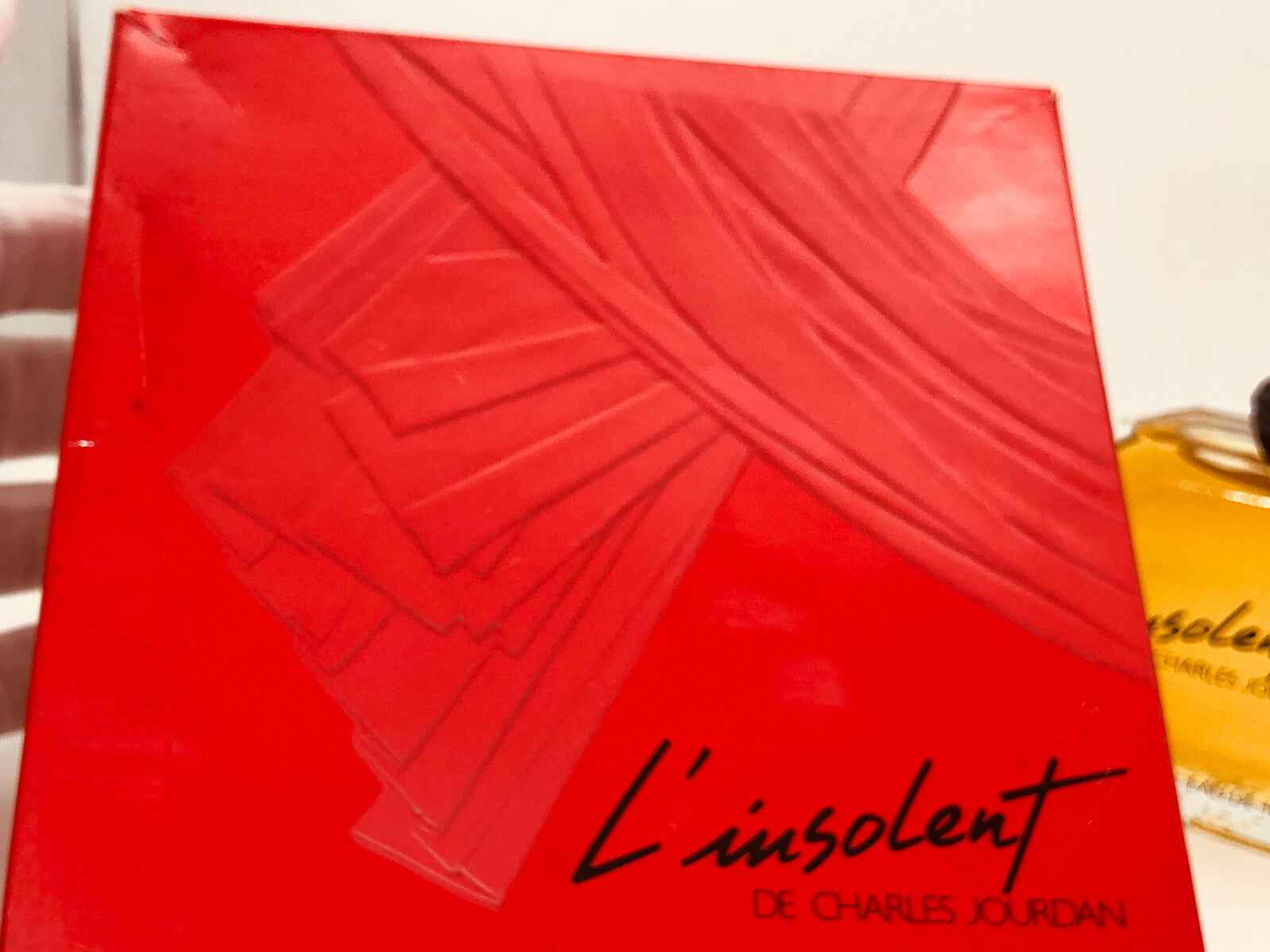 Scatola rossa del profumo L'insolent Charles Jourdan con design elegante e raffinato
