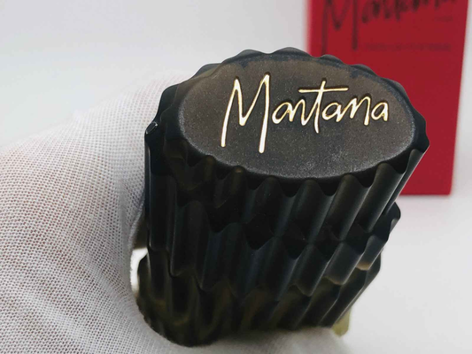 Flacone di Claude Montana Parfum Homme in vetro nero con logo dorato Montana sul tappo