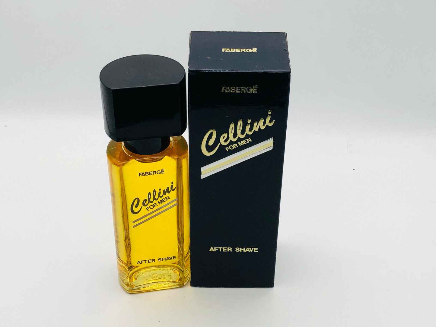 Profumo dopo barba Faberge Cellini Vintage in bottiglia gialla con scatola nera elegante