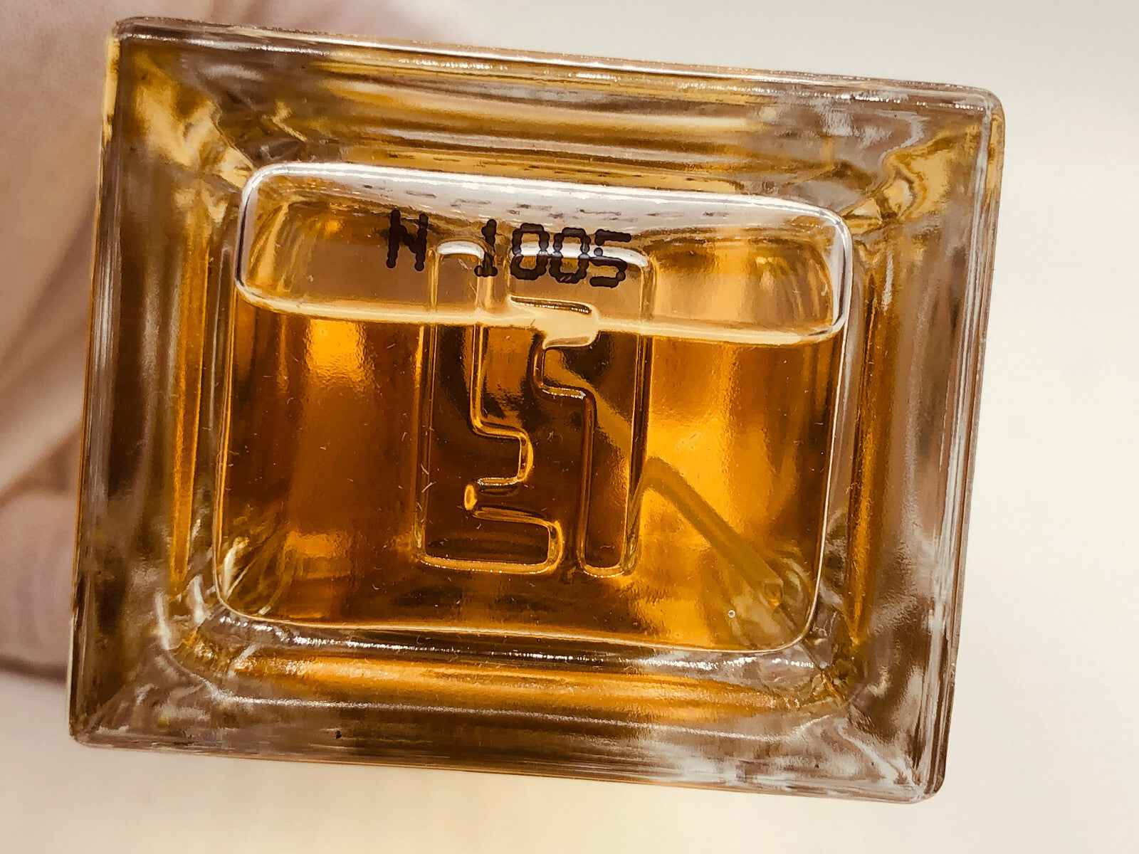 Bottiglia di profumo Fendi Life Essence con liquido ambrato e design elegante