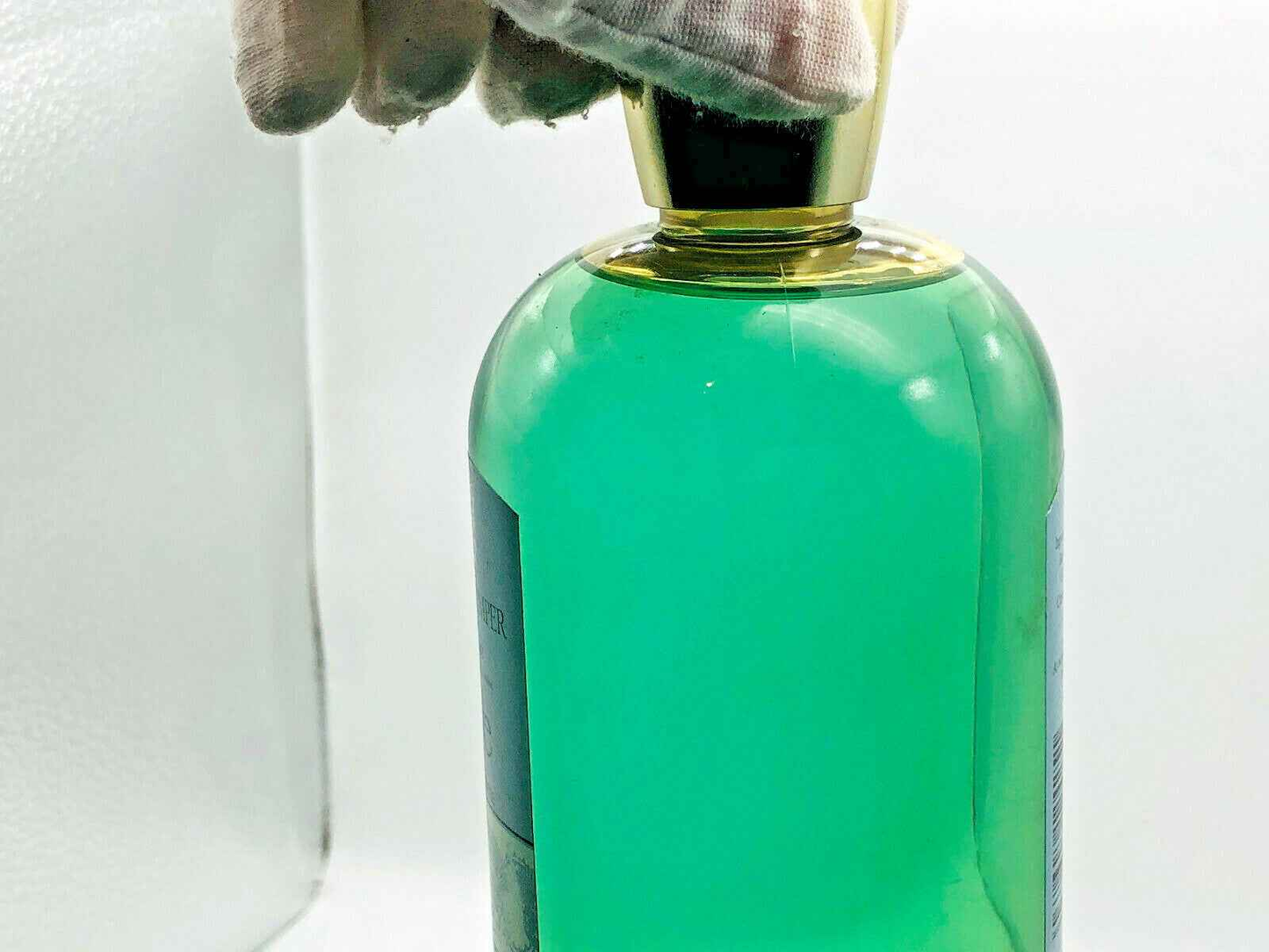 Flacone di profumo Geo F Trumper Skye con tappo dorato e liquido verde chiaro