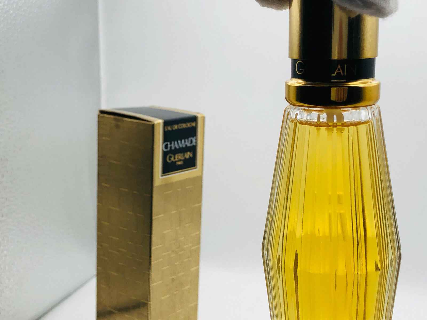 Flacone di profumo Guerlain Chamade Vintage con packaging dorato e design elegante