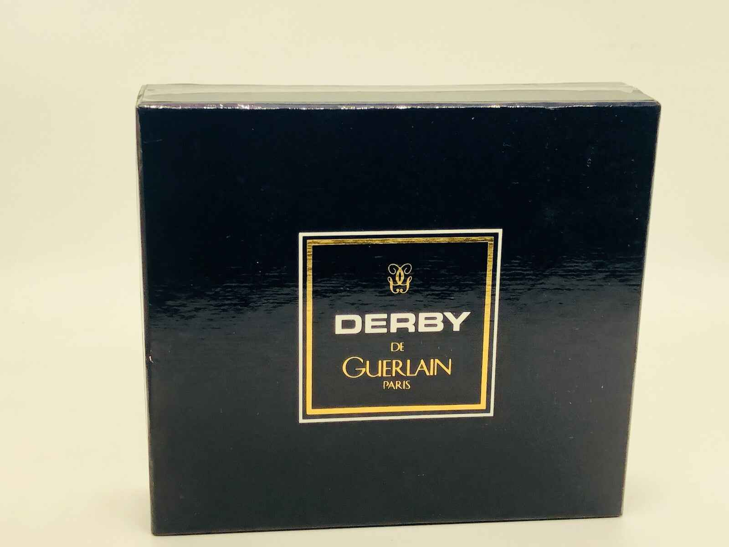 Confezione vintage Derby Guerlain con design elegante e logo dorato per gli amanti della profumeria raffinata
