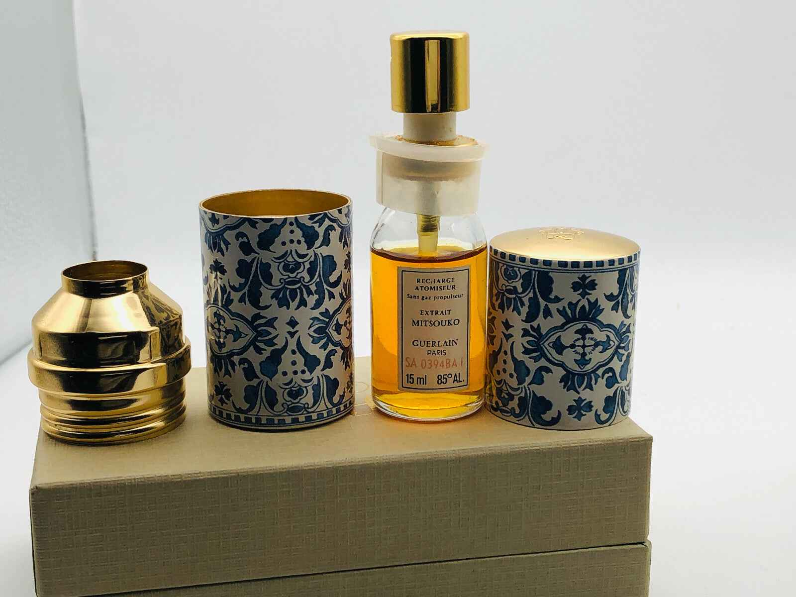 Guerlain Mitsouko Parfum in elegant bottle with decorative packaging and gold accents