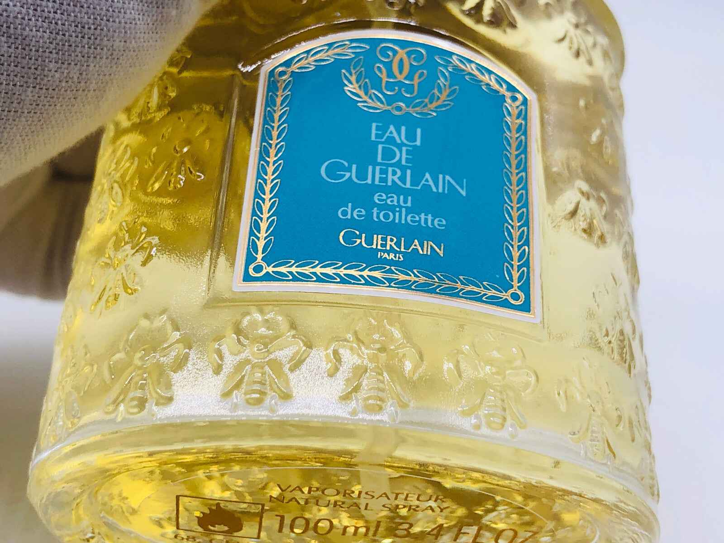 Flacone di profumo Eau De Guerlain in formato da 100 ml con etichetta elegante e design raffinato.