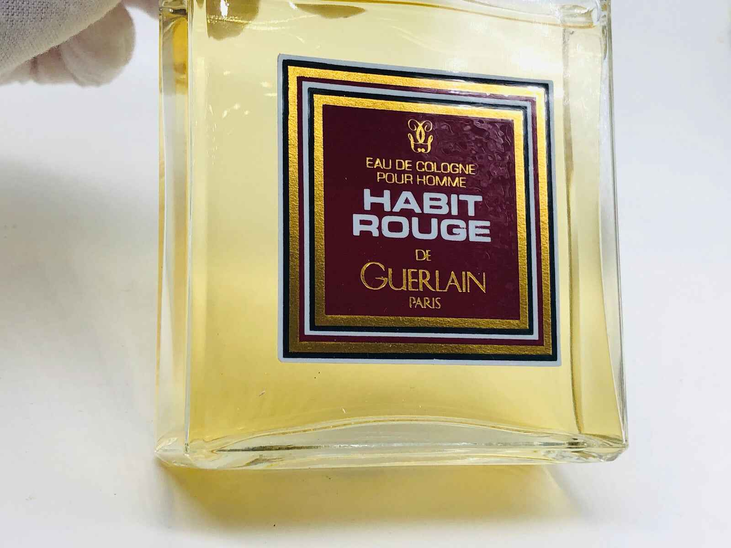 Profumo Guerlain Habit Rouge Vintage in bottiglia elegante con etichetta rossa e oro