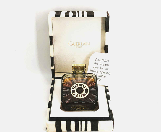 Profumo Guerlain Vol De Nuit Vintage in elegante confezione con design distintivo e avviso per l'apertura