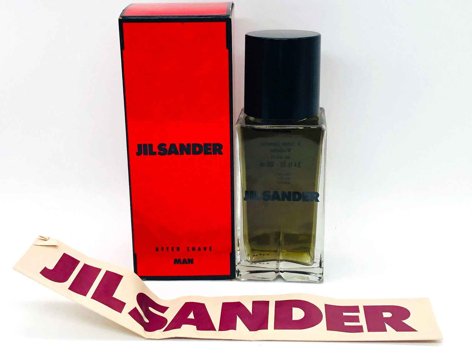 Profumo Jil Sander Feeling Man in flacone trasparente con scatola rossa e etichetta distintiva