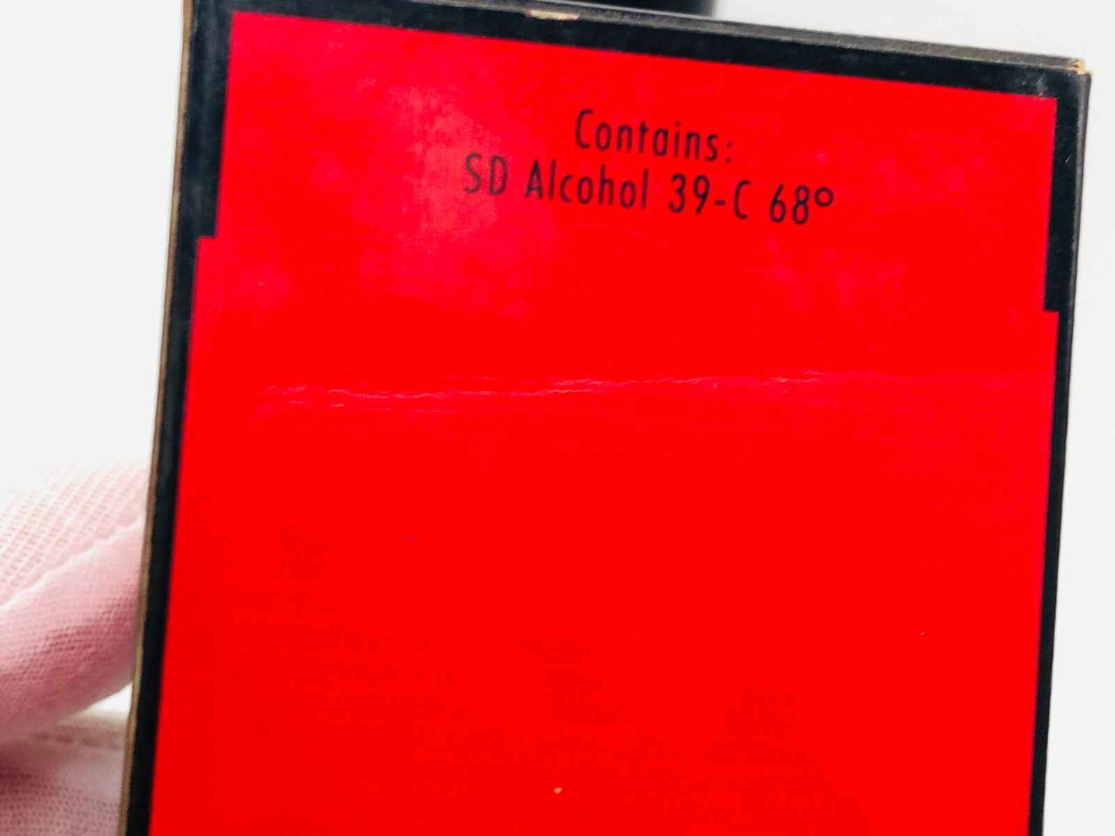 Flacone di profumo Jil Sander Feeling Man con etichetta rossa e ingredienti elencati sul retro