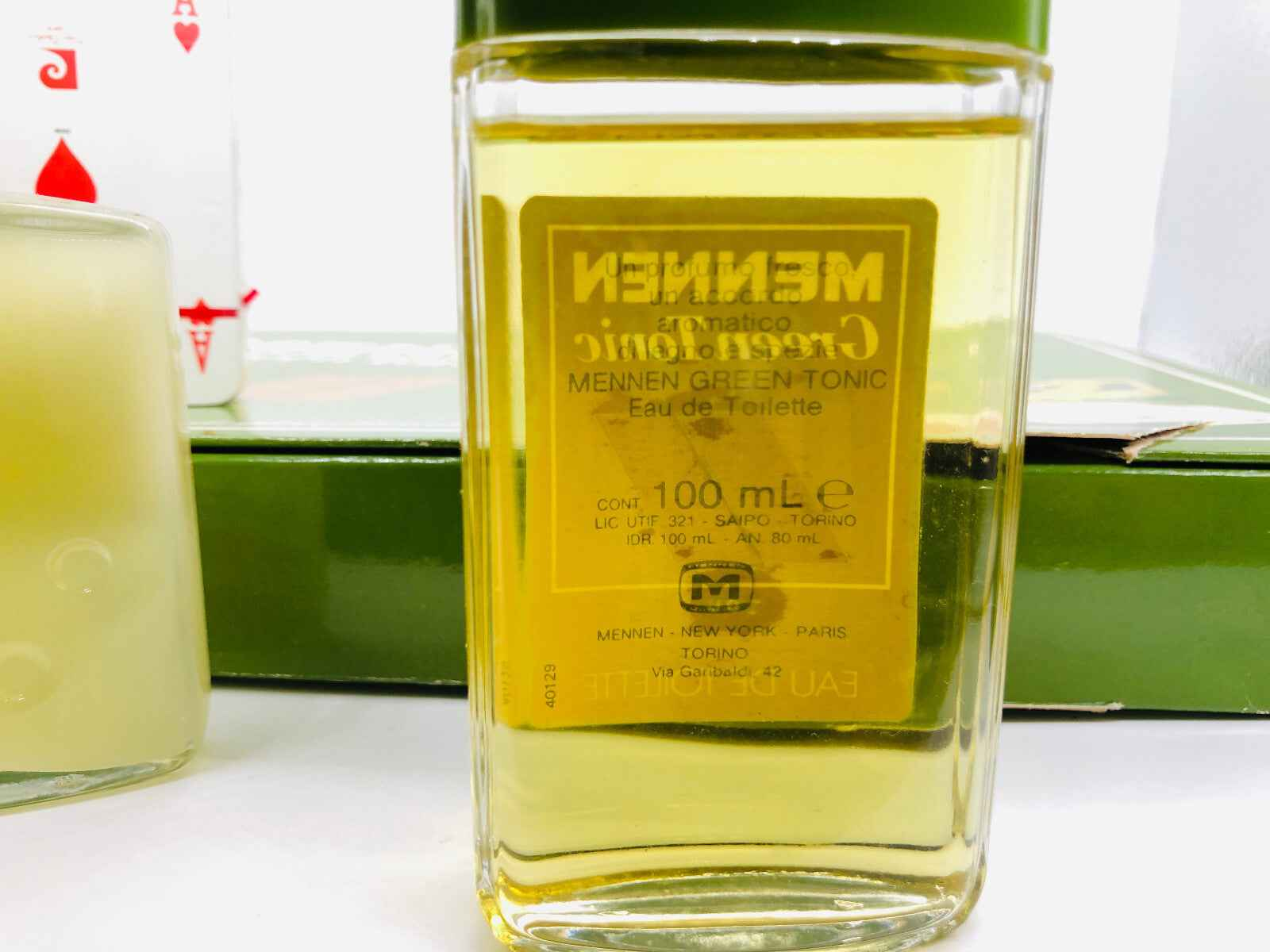 Flacone di profumo Green Tonic Mennen da 100 ml con etichetta gialla e tappo verde