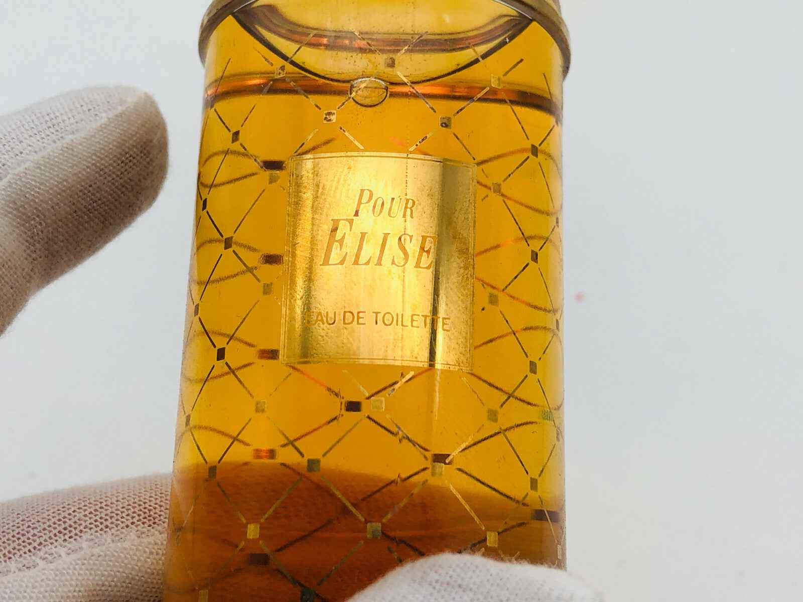 Flacone di profumo Pour Elise Perlier in vetro con decorazioni dorate e liquido ambrato