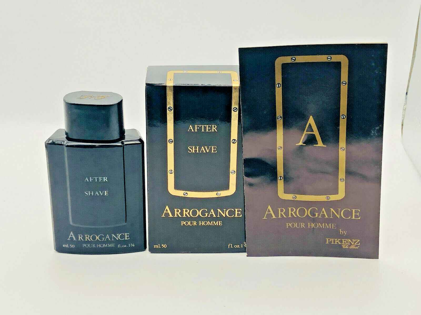Bottiglia e confezione di Arrogance Pour Homme after shave con design elegante nero e oro