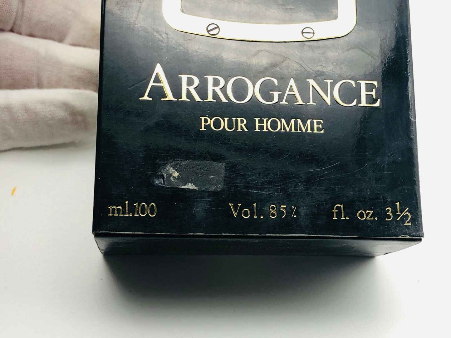 Scatola di profumo Arrogance Pour Homme da 100 ml con design elegante e dettagli in oro