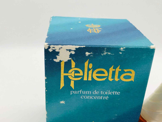 Confezione del profumo Helietta Caracciolo con design blu e dorato, note di eleganza e freschezza.