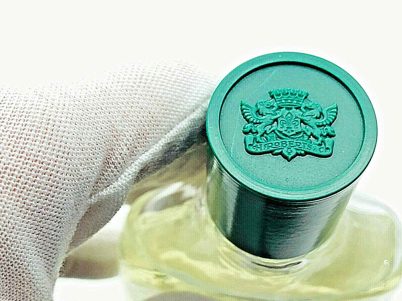 Tappo verde del profumo Roberts Colonia Bambini con logo distintivo, ideale per piccole fragranze.