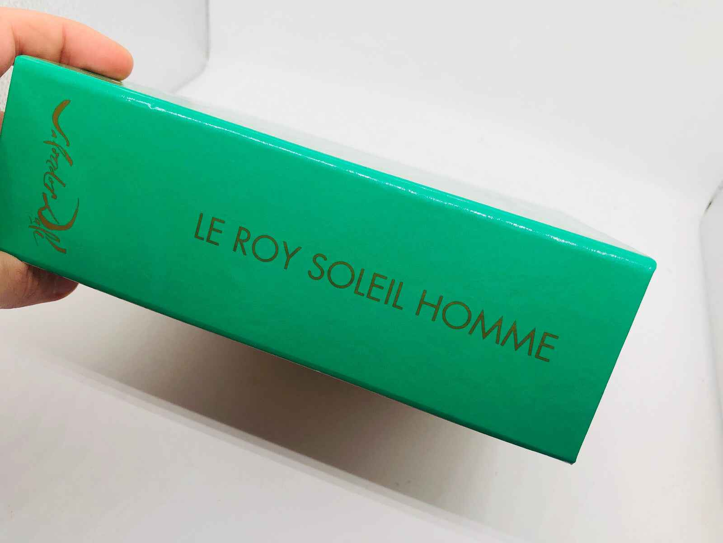 Scatola del profumo Le Roy Soleil Salvador Dali con finitura verde e scritta dorata