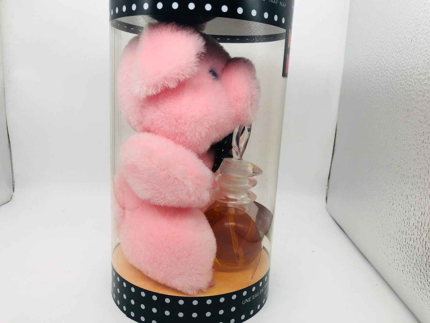 Un Touche Naf Naf Profumo Vintage in confezione con peluche rosa originale e bottiglia di profumo.