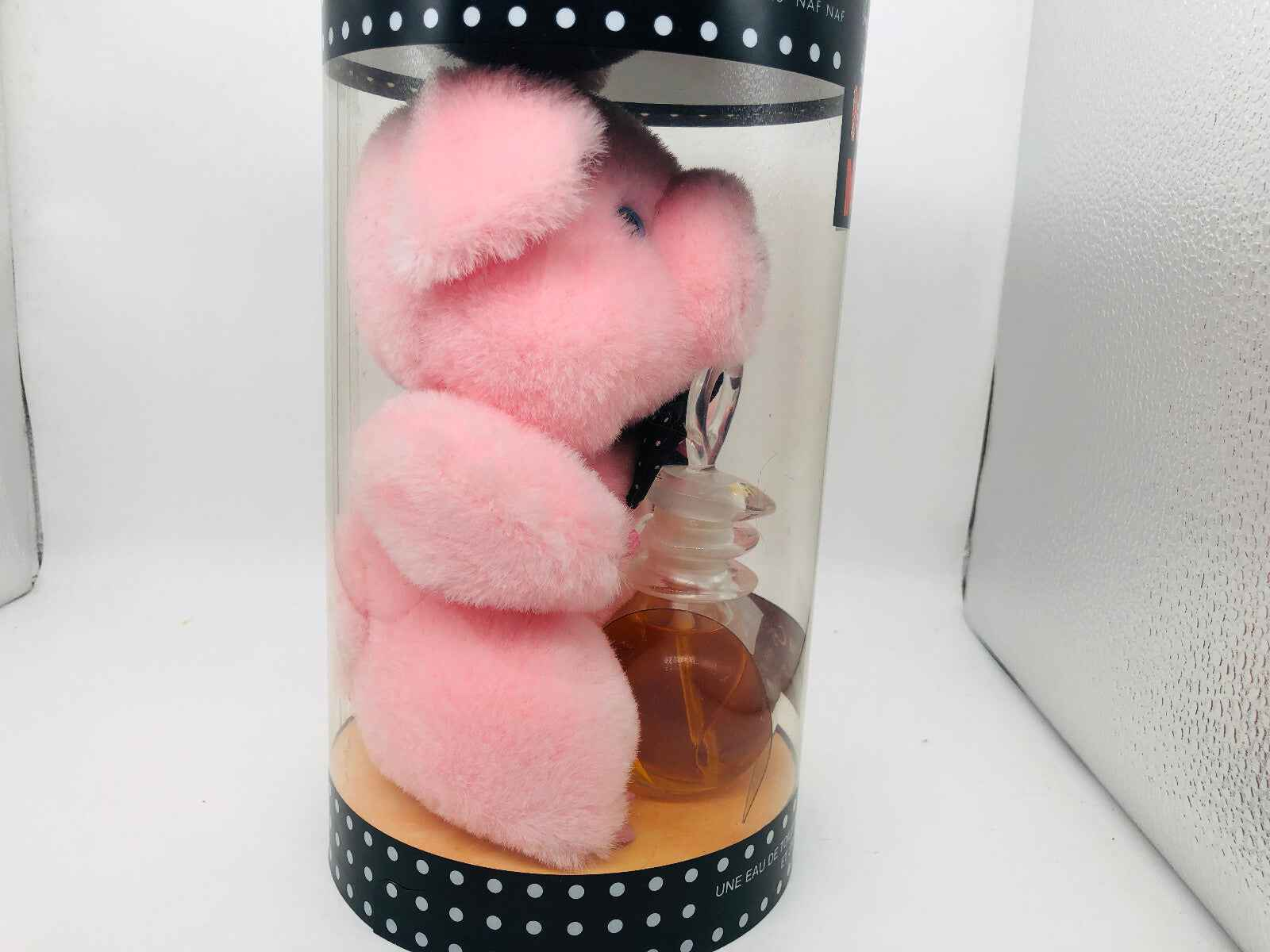Un Touche Naf Naf Profumo Vintage in confezione con peluche rosa originale e bottiglia di profumo.