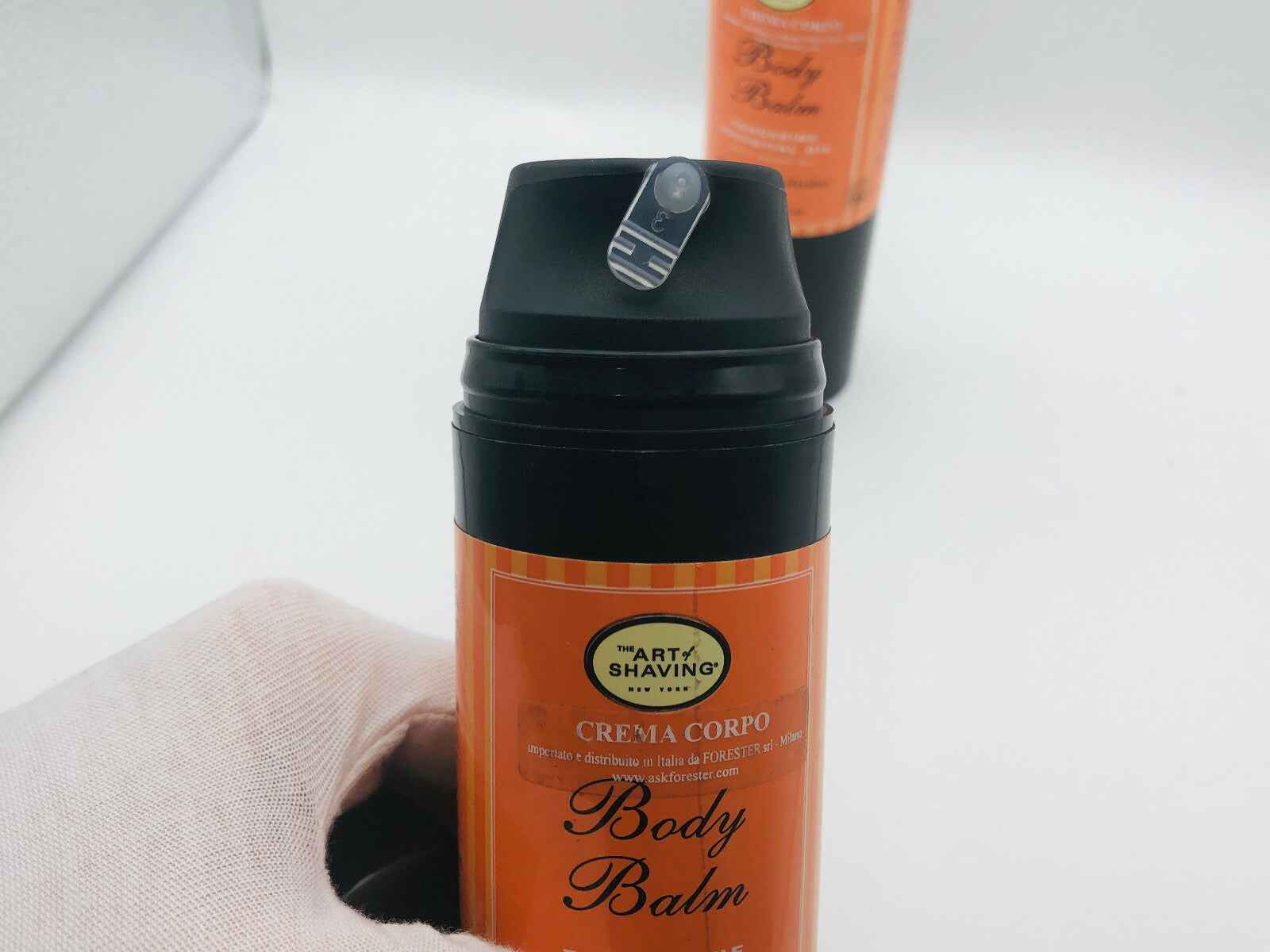 Art Of Shaving Body Balm in an orange container for moisturized and refreshed skin.