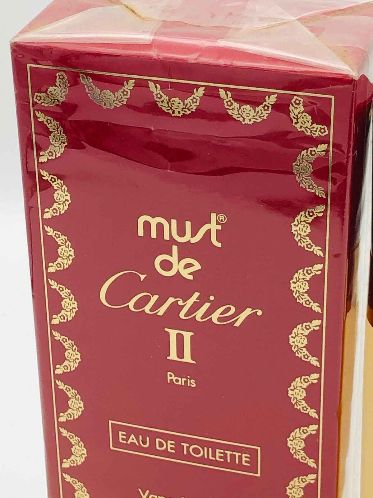 Scatola di profumo Must De Cartier II in rosso con elegante design per un tocco di lusso