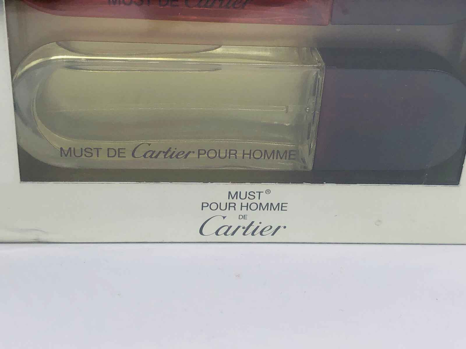 Set di profumi Cartier Must de Cartier pour homme con eleganti flaconi trasparenti