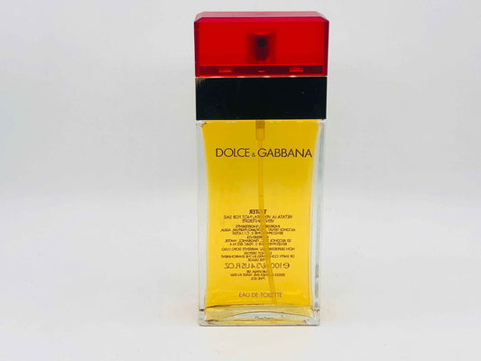 Flacone di profumo Dolce E Gabbana, Eau de Toilette con tappo rosso e liquido giallo dorato