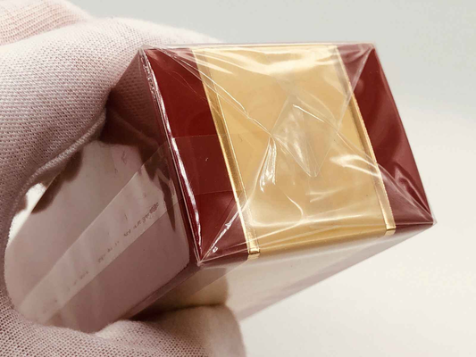 Scatola di profumo Estée Lauder Cinnabar Vintage con riflessi dorati e imballaggio in plastica