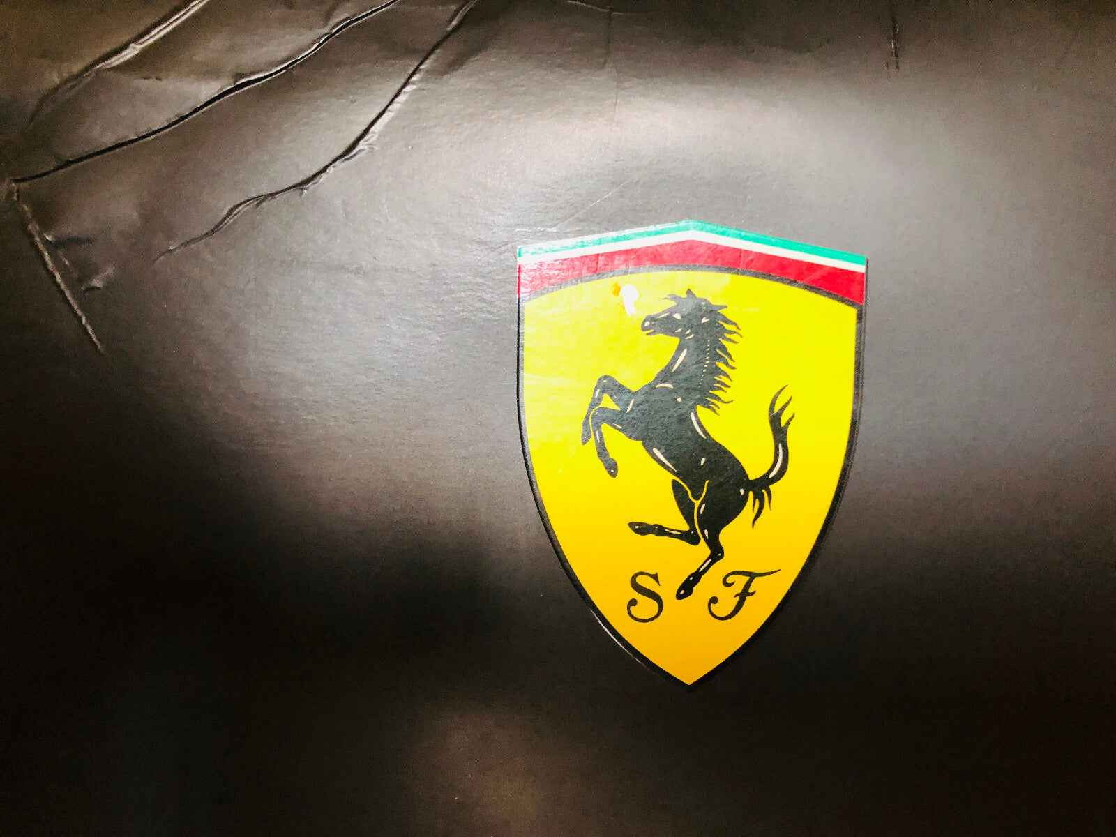 Logo Ferrari su sfondo nero, simbolo del profumo Ferrari Black Vintage