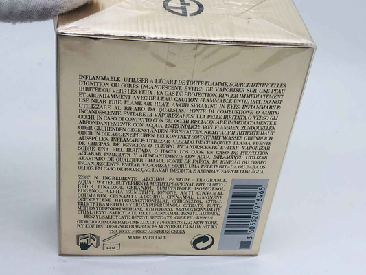 Confezione del profumo Idole Armani in oro con avvertenze di sicurezza sul retro