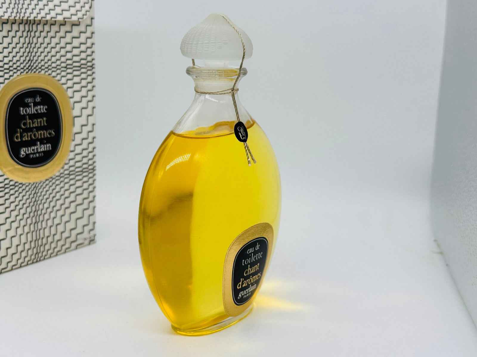 Flacone di profumo Guerlain Chant D'Aromes Vintage con etichetta elegante e tonalità dorata