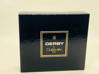 Confezione vintage Derby Guerlain con design elegante e logo dorato per gli amanti della profumeria raffinata