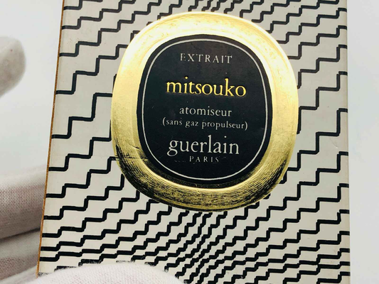 Guerlain Mitsouko Parfum in elegant packaging with a gold emblem and black accents