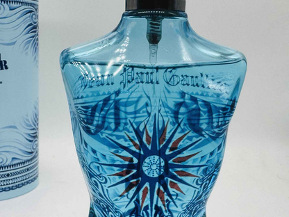 Gaultier Le Male Summer Cologne in a blue bottle with red star design and Jean Paul Gaultier branding