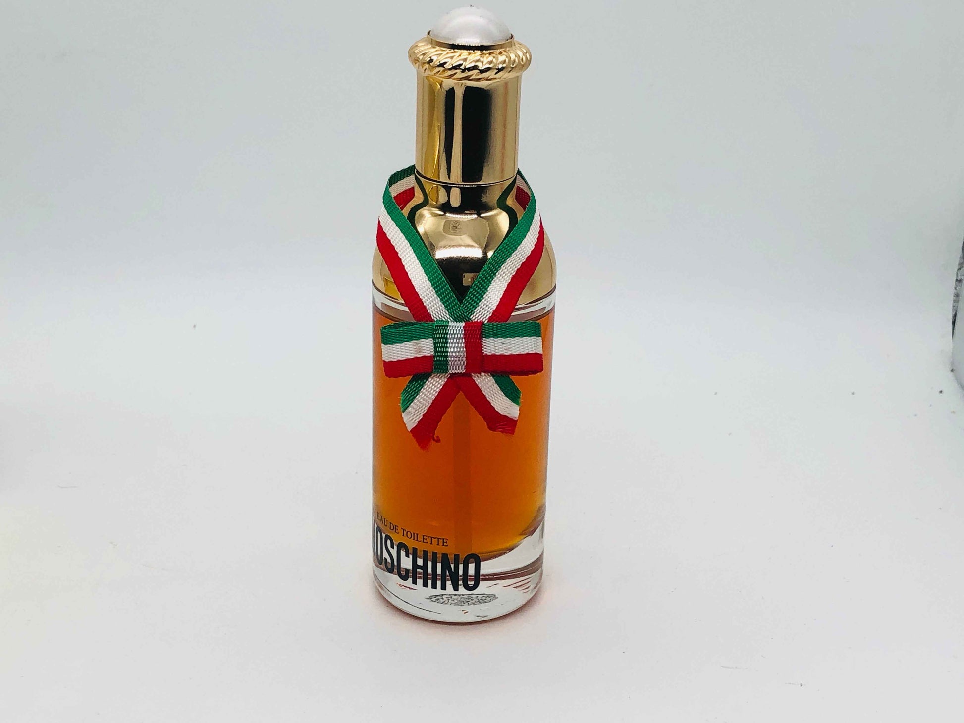 Flacone di profumo Moschino Donna Vintage con dettagli dorati e nastro colorato