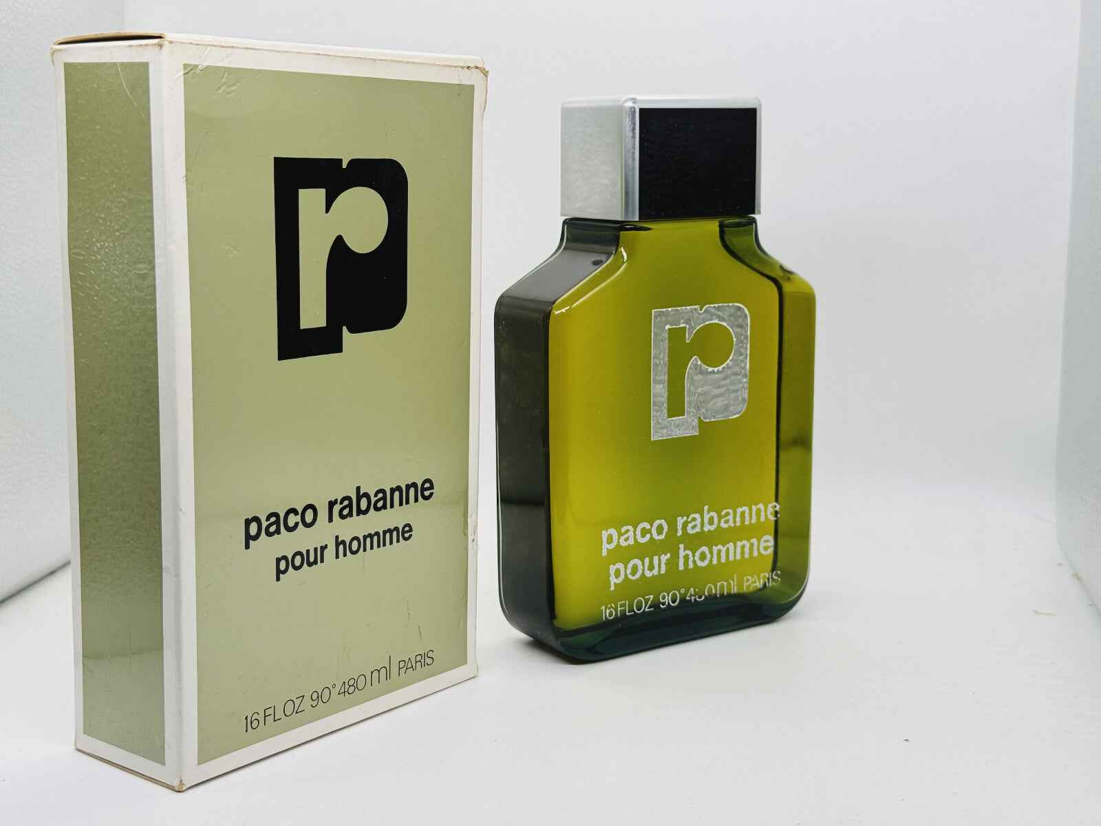 Profumo Paco Rabanne Pour Homme Vintage in bottiglia verde con scatola originale in bianco e nero