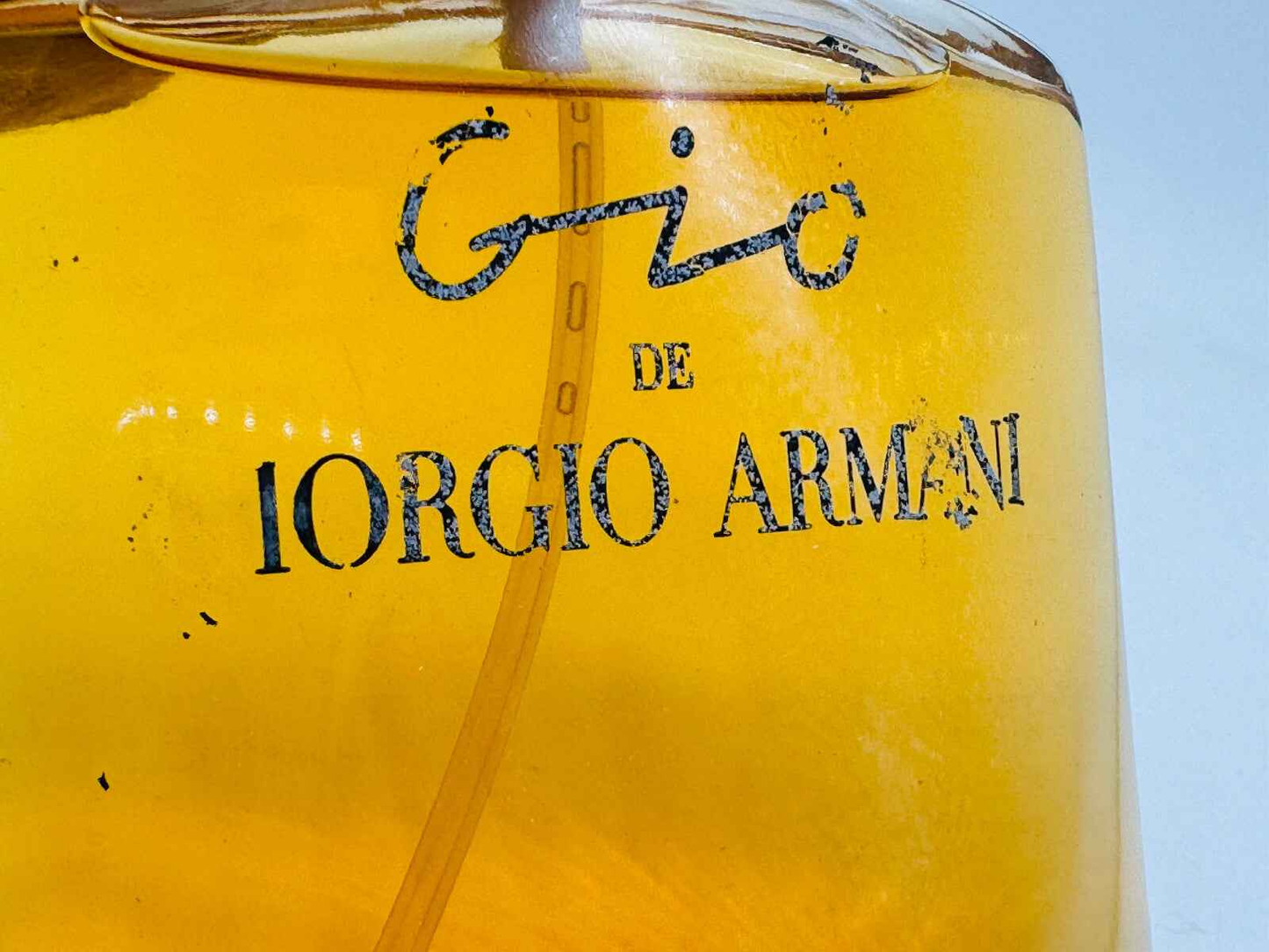 Flacone di Profumo Armani Gio Vintage con etichetta di Giorgio Armani e liquido dorato