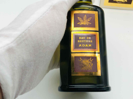 Flacone di Profumo Vintage Adam Eau De Bruyere con etichetta dorata e design classico