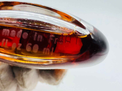 Bottiglia di profumo First Van Cleef & Arpels in vetro marrone con dettagli eleganti