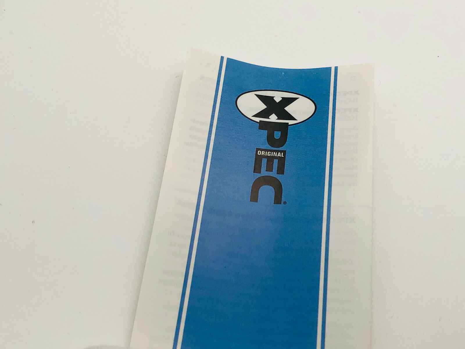 Etichetta della Xpec Original Lozione Corpo con design blu e logo distintivo al centro