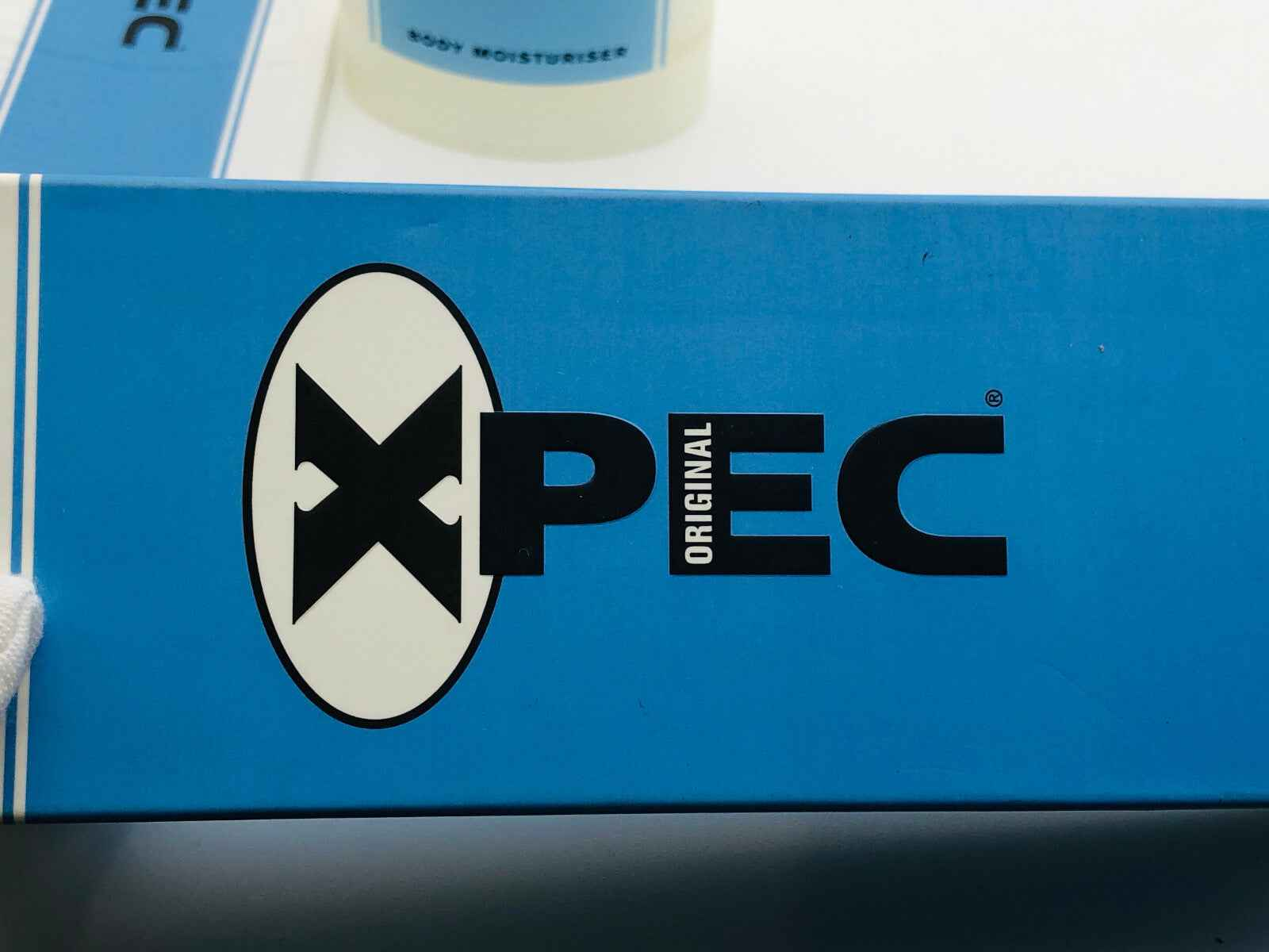Scatola della Xpec Original Lozione Corpo con design blu e logo ben visibile
